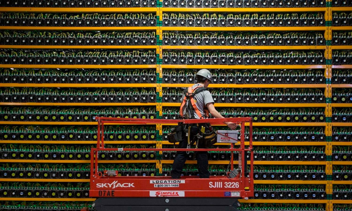 A technician inspects the backside of a cryptocurrency mining farm in Saint Hyacinthe, Quebec. Talos discovered a new cryptocurrency-mining botnet attack, Prometei, that bypasses detection systems and monetizes its campaigns in less intrusive ways. (LARS HAGBERG/AFP via Getty Images)