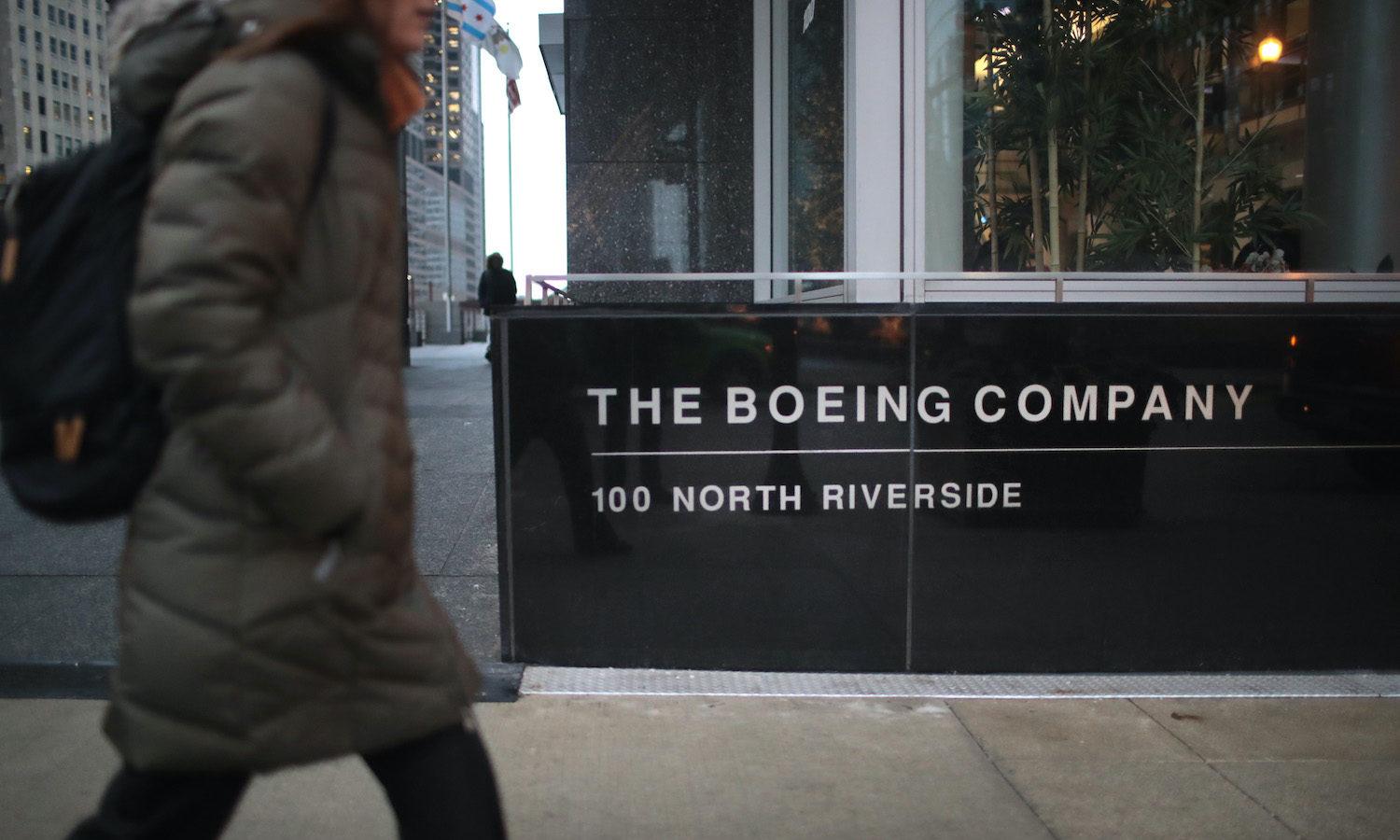 A pedestrian walks by the headquarters of The Boeing Co. on Jan. 29, 2020, in Chicago. The Department of Homeland Security, FBI and NSA are warning about a two-year Russian campaign targeting defense contractors.  (Photo by Scott Olson/Getty Images)