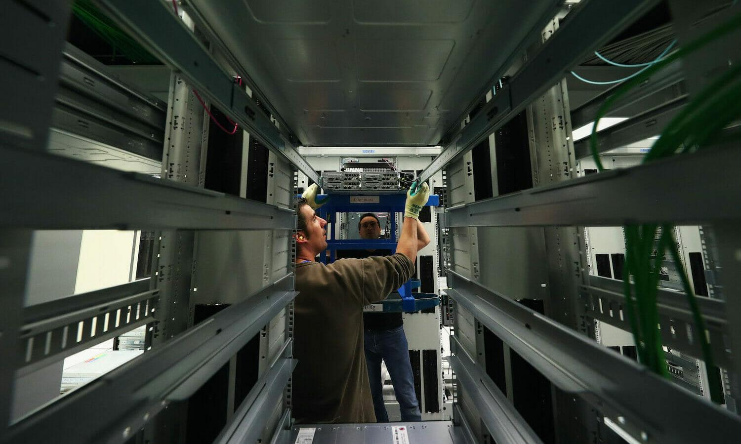 Staff work in a data center and server farm  in Switzerland. (Dean Mouhtaropoulos/Getty Images)