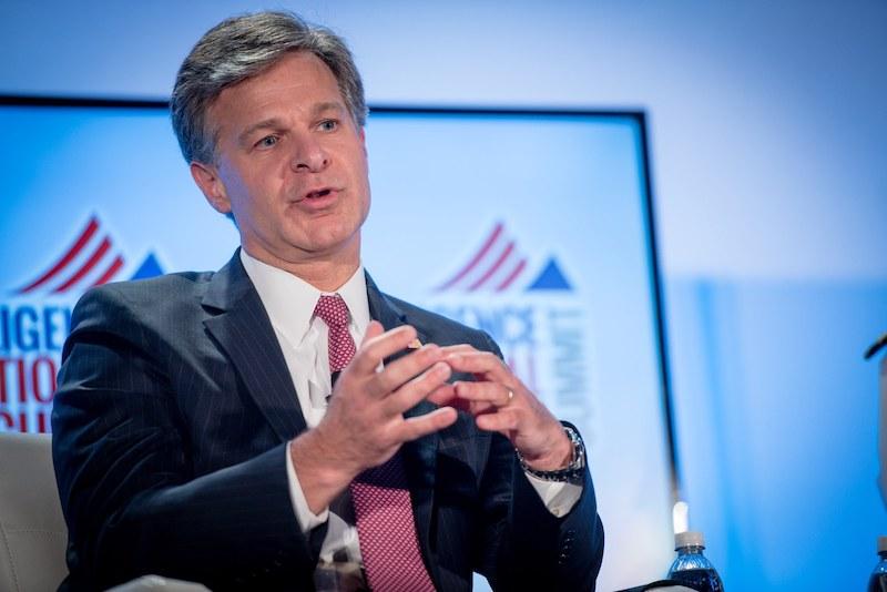 FBI Director Christopher Wray speaks at an event in Washington, D.C. The FBI reports that BEC scams cost organizations more than $26 billion worldwide between 2016 and 2019. Today’s columnist, David Jemmett of Cerberus Sentinel, describes how BECs have become even more targeted in the past year.