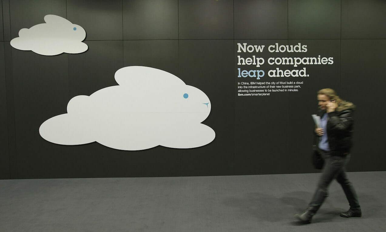 A woman speaking on a mobile phone walks past a cloud computing presentation ahead of the CeBIT  technology trade fair in 2012. Researchers at Positive Technologies said some bad actors are aggressively exploiting vulnerabilities already found in software for deploying virtual infrastructure. (Sean Gallup/Getty Images)