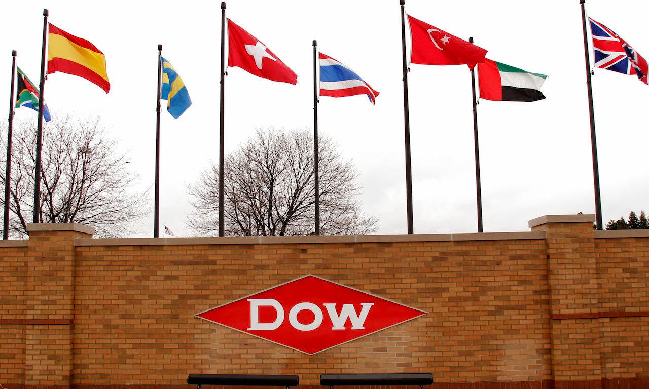 Flags and the Dow logo at the main entrance of the Dow world headquarters complex is shown April 12, 2007 in Midland, Michigan. (Photo by Bill Pugliano/Getty Images)