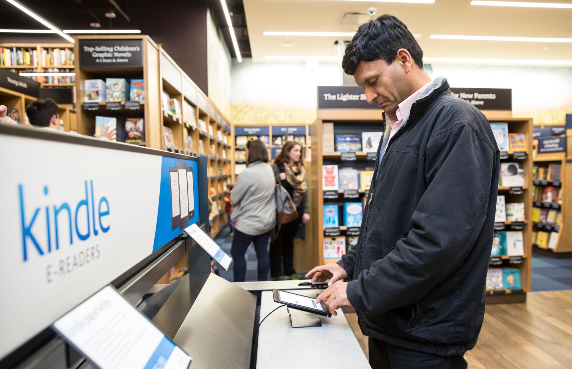 A customer uses a Kindle tablet device at the newly opened Amazon Books store on Nov. 4, 2015, in Seattle. (Stephen Brashear/Getty Images)
