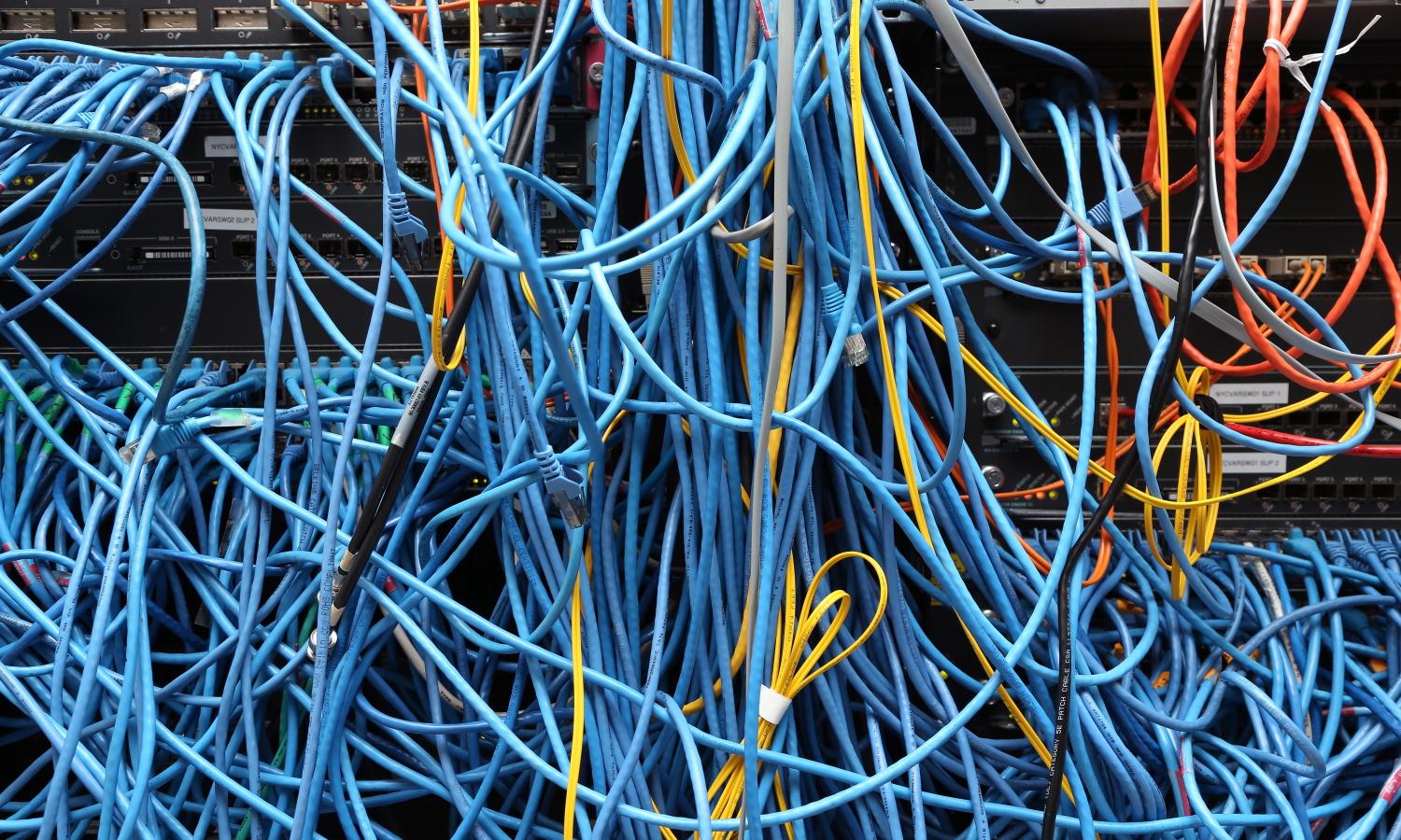 Network cables are plugged in a server room on Nov. 10, 2014, in New York City. A lot goes into the planning on how to ensure everyone attended the conference receives good service, said Bill Swearengen, strategist with Black Hat network operations center vendor IronNet. (Michael Bocchieri/Getty Images)