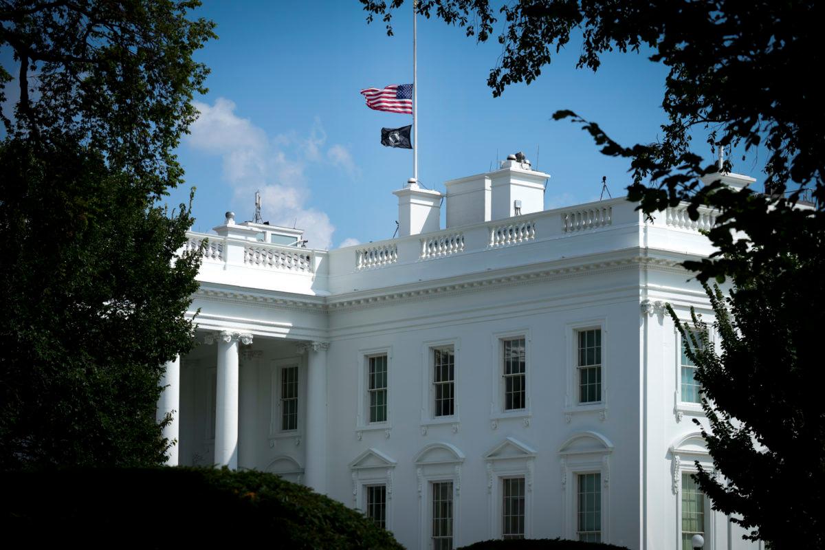 WASHINGTON, DC &#8211; AUGUST 27: The American flag and National League of Families POW/MIA Flag on top of the White House stand at half staff to honor the U.S. service members killed in terror attacks in Kabul Afghanistan, on August 27, 2021 in Washington, DC. The White House&#8217;s administrative arm released a memo on how agencies should be log...
