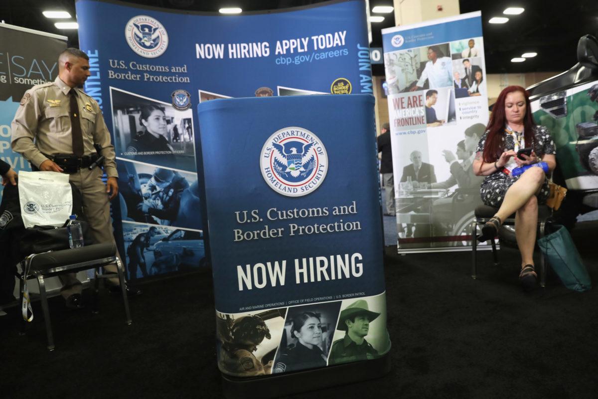 A Homeland Security agent mans an exhibit at the Border Security Expo on April 12, 2017, at the Henry B. Gonzalez Convention Center in San Antonio. A White House advisory council approved nine different recommendations around how to boost hiring in the federal government and critical infrastructure, particularly for cybersecurity jobs. (Photo by J...