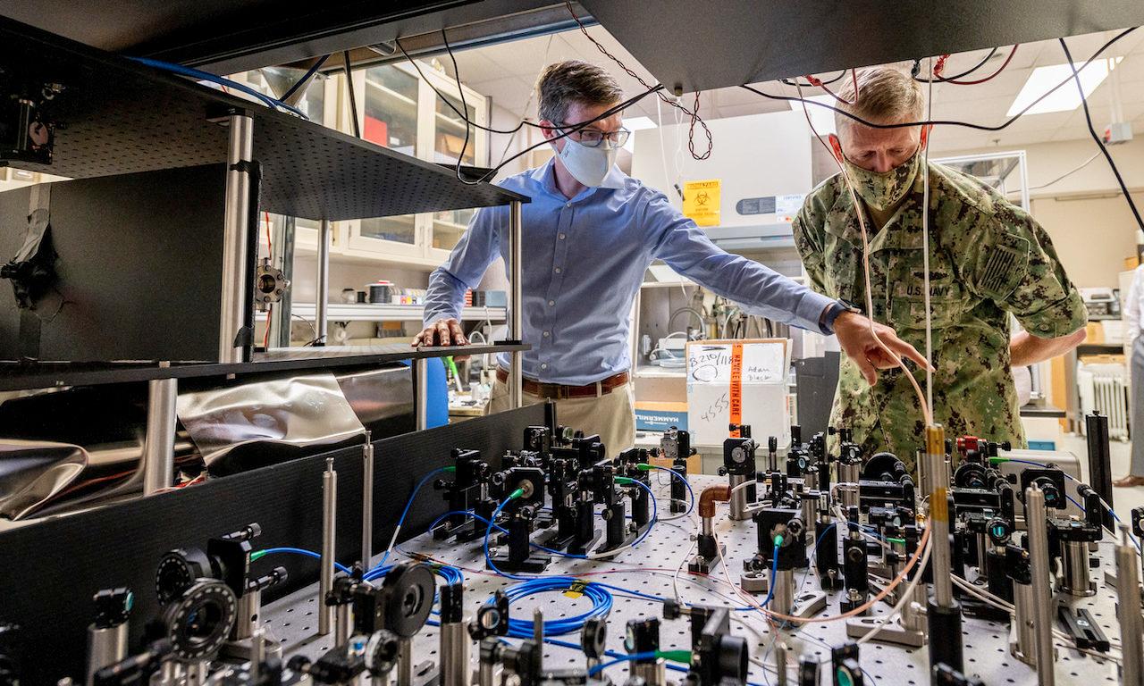 Jonathan Kwolek, a U.S. Naval Research Laboratory research physicist, shows an atom interferometer to Chief of Naval Research Rear Adm. Lorin Selby, Sept. 14, 2020, at the Navy’s Quantum Information Research Center