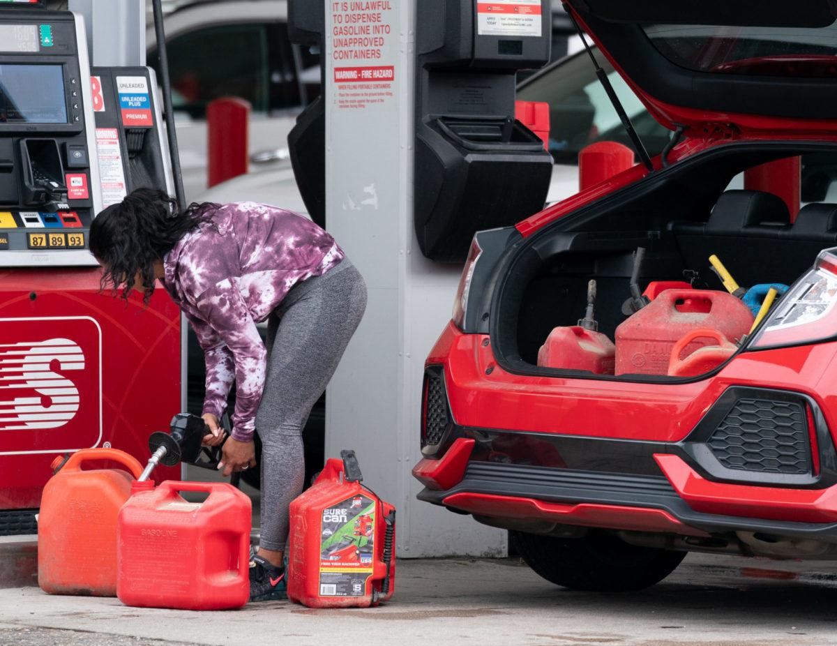 A woman fills gas cans at a Speedway gas station on May 12, 2021, in Benson, N.C., due to gas shortages following the Colonial Pipeline ransomware attack. A bipartisan bill that would identify entities like Colonial Pipeline as &#8220;systemically important&#8221; critical infrastructure gained the support of CISA Director Jen Easterly. (Photo by ...