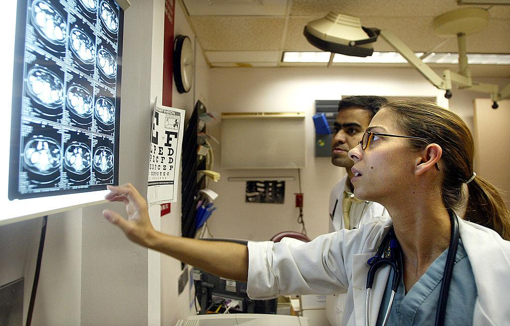 Dr. Karen Barbosa views CT scans in the emergency room at Coney Island Hospital Oct. 5, 2002, in the Brooklyn borough of New York City. (Photo by Mario Tama/Getty Images)