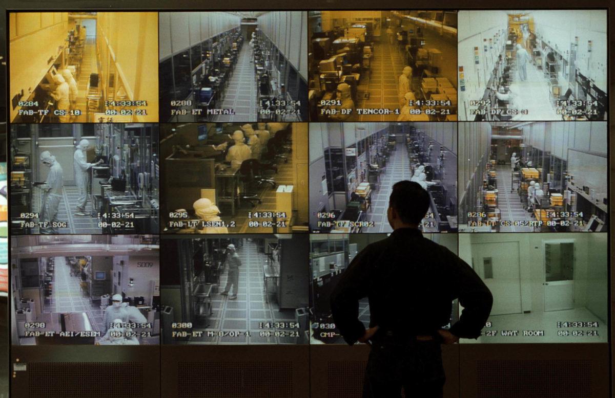 A visitor to United Manufacturing Corporation observes semiconductor manufacturing on wall of monitors in the company&#8217;s reception area, Hsinchu, Taiwan, May 1, 2000. Semiconductor chips were one of five technologies cited by the National Counterintelligence Security Center as being essential to long-term U.S. economic and security needs. (Pho...