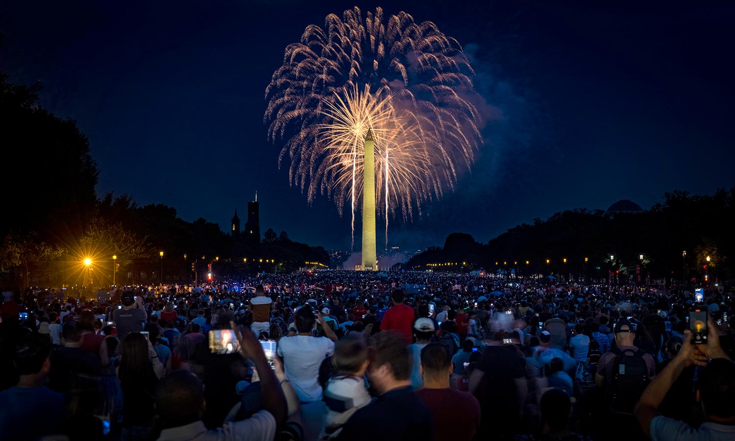 People fill the National Mall to watch the fireworks display during Independence Day celebrations on July 4, 2021, in Washington. (Photo by Samuel Corum/Getty Images)