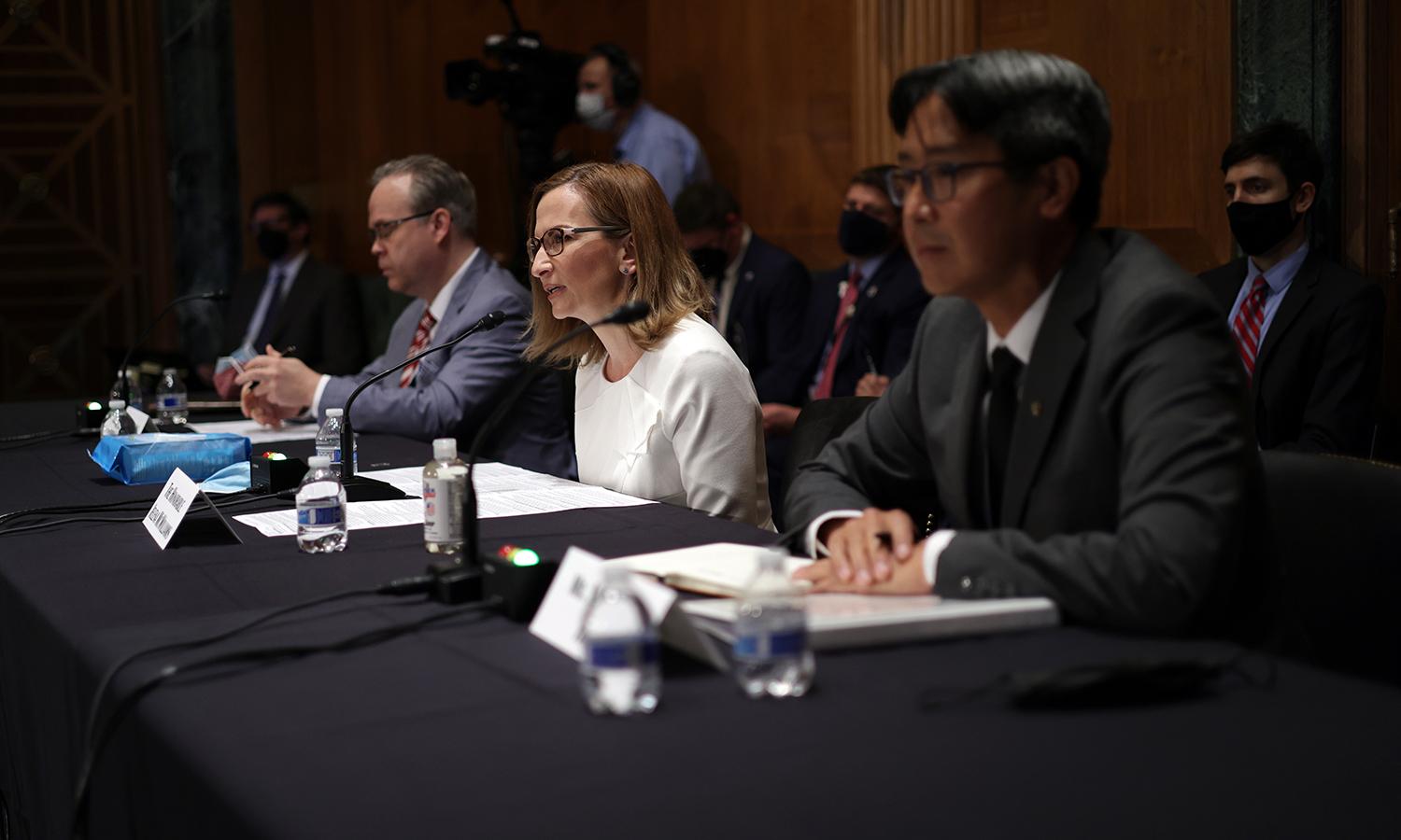 From left: Chairman of National Credit Union Administration (NCUA) Todd Harper, Chairman of Federal Deposit Insurance Corporation (FDIC) Jelena McWilliams and Acting Comptroller of the Currency Michael Hsu testify during a hearing before the Senate Banking, Housing and Urban Affairs Committee on Aug. 3, 2021, in Washington. (Photo by Alex Wong/Gett...