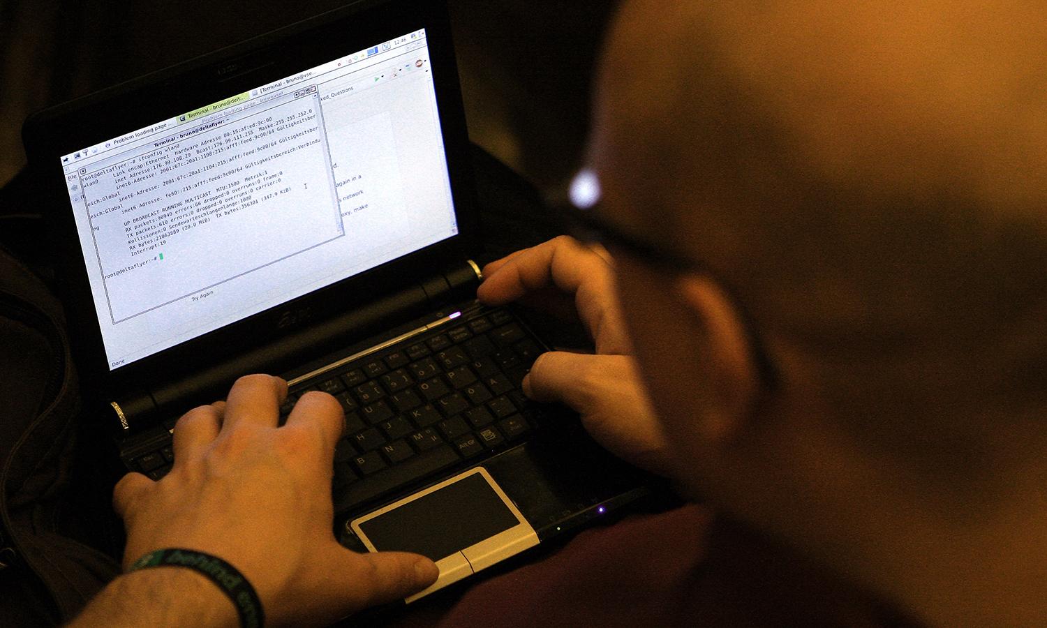 A participant looks at lines of code on a laptop on the first day of the 28th Chaos Communication Congress computer hacker conference on Dec. 27, 2011, in Berlin. (Photo by Adam Berry/Getty Images)