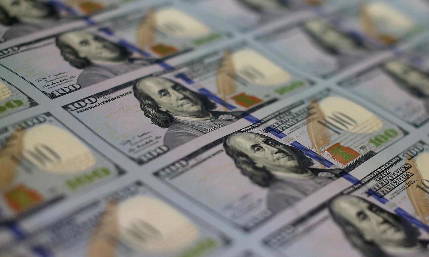 Newly redesigned $100 notes lay in stacks at the Bureau of Engraving and Printing on May 20, 2013, in Washington. (Photo by Mark Wilson/Getty Images)