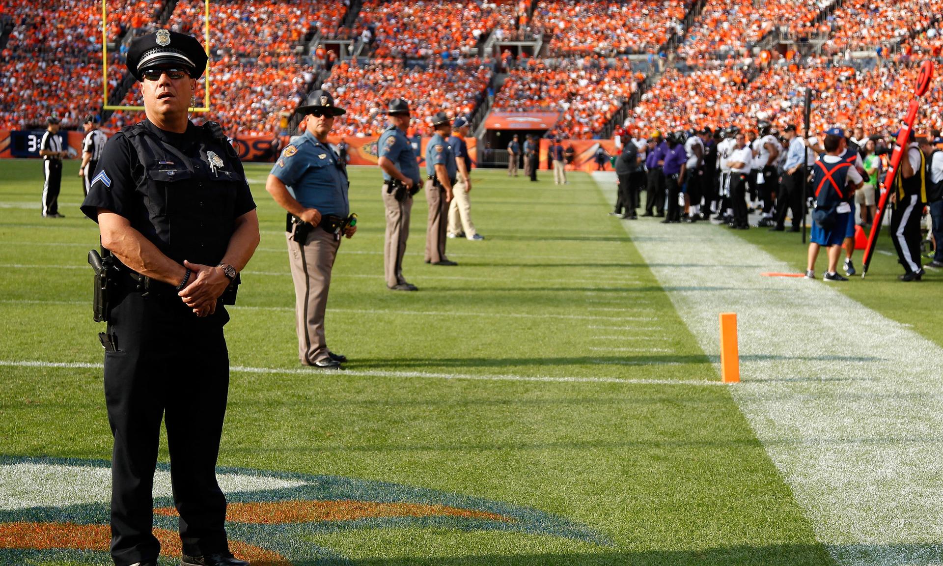 Law enforcement officers help secure a 2015 NFL game between the Baltimore Ravens and the Denver Broncos. (Photo by Doug Pensinger/Getty Images)