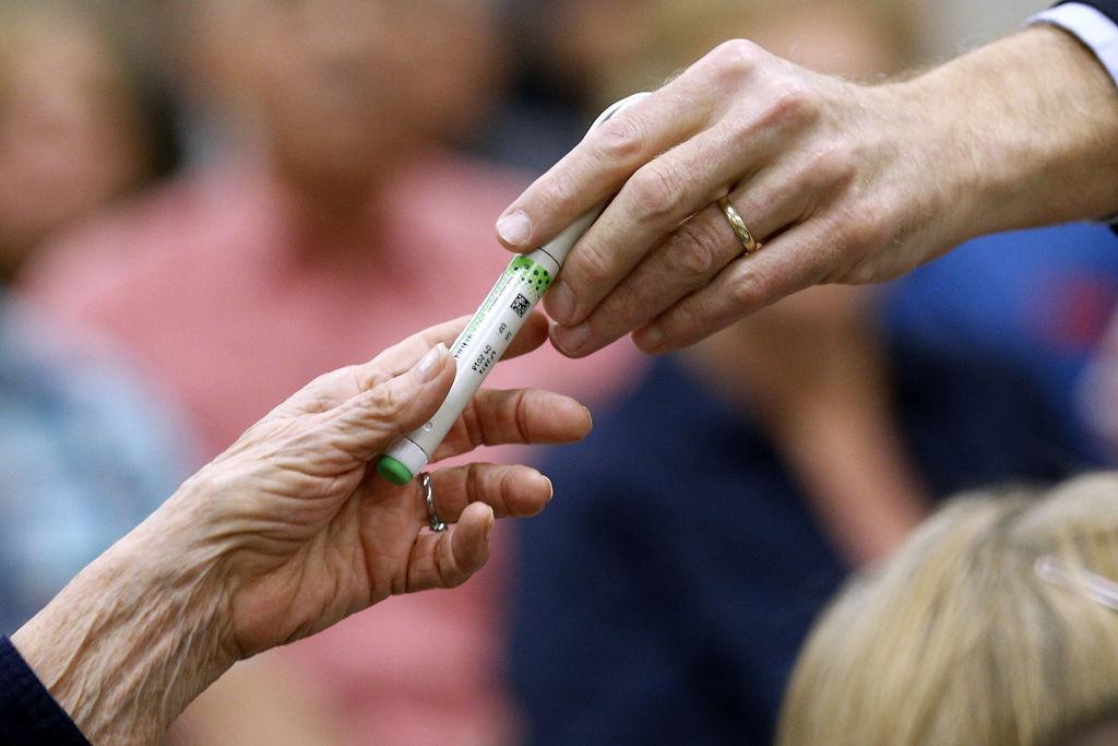 A woman hands an insulin pen to Sen. Bill Cassidy, R-La., during a town hall meeting on Feb. 23, 2017, in Thibodaux, La. (Photo by Jonathan Bachman/Getty Images)