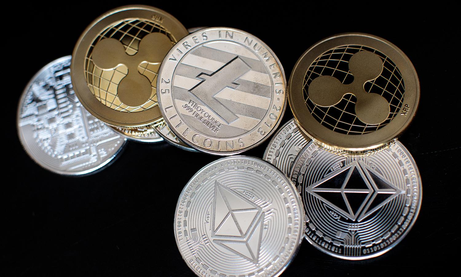 The litecoin, ripple and ethereum cryptocurrency &#8220;altcoins&#8221; sit arranged for a photograph on April 25, 2018, in London. (Jack Taylor/Getty Images)