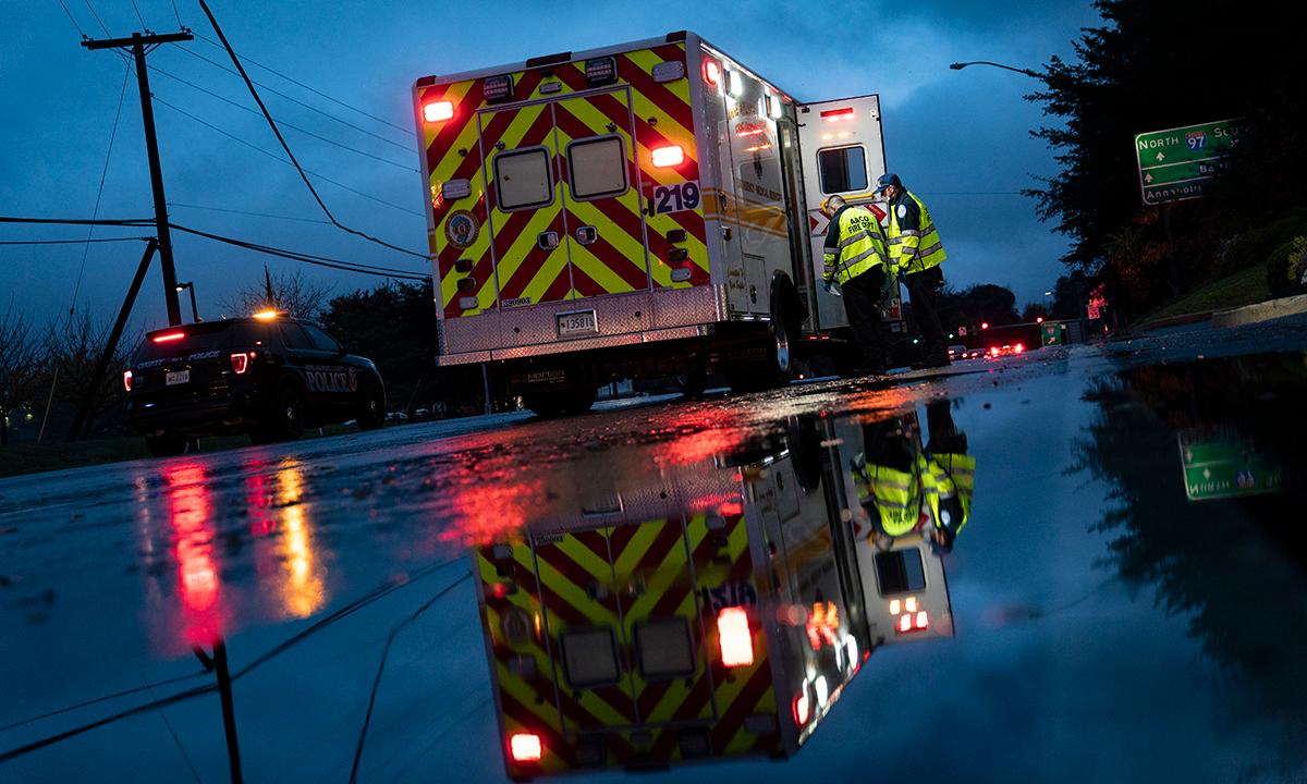 Firefighters and paramedics with Anne Arundel County Fire Department board their ambulance after loading a patient while responding to a 911 emergency call on Nov. 11, 2020, in Glen Burnie, Md. (Photo by Alex Edelman/Getty Images)