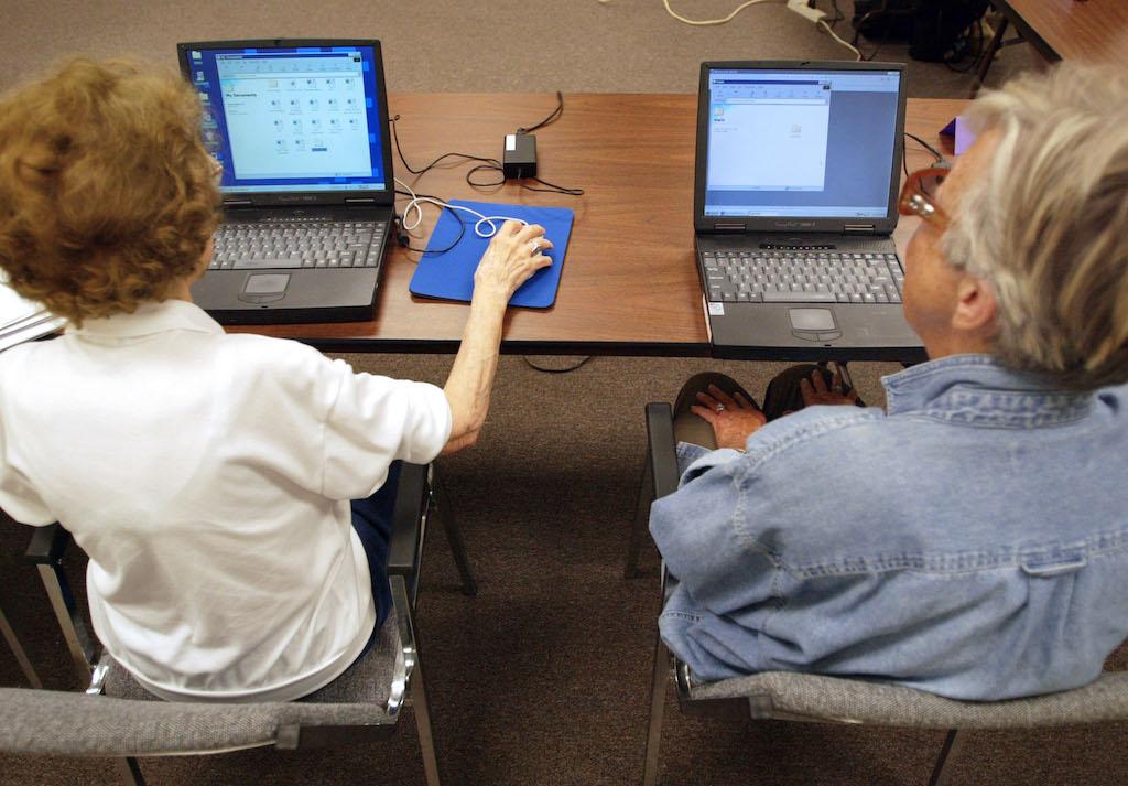 Two senior citizens work on their laptop computers during an &#8220;Introduction to Microsoft Word&#8221; computer class. Fraudsters are targeting the higher number of elderly people online, particularly during COVID.  (Photo by Tim Boyle/Getty Images)