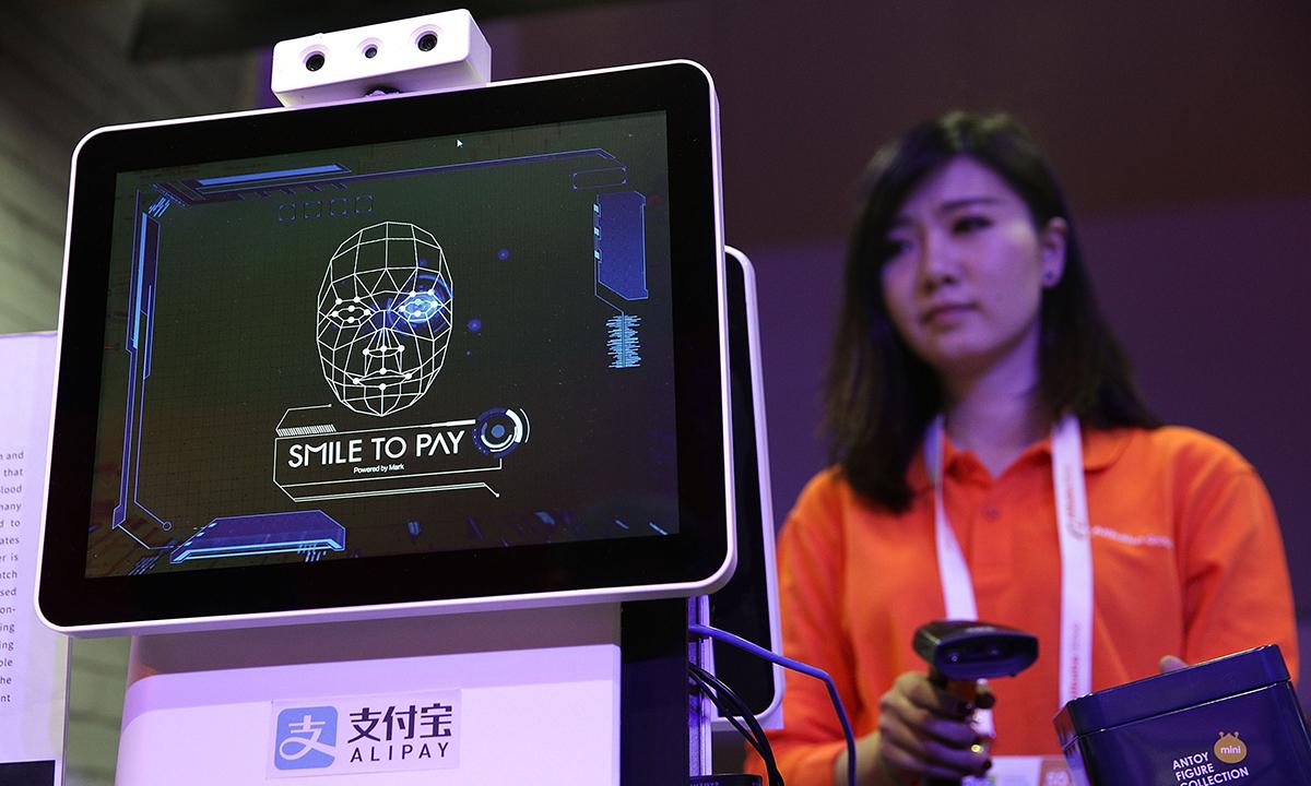 An Alibaba employee demonstrates &#8220;Smile to Pay,&#8221; an automatic payment system that authorize payment via facial recognition, at the Alibaba booth during CES 2017 at the Las Vegas Convention Center on Jan. 5, 2017, in Las Vegas. (Photo by Alex Wong/Getty Images)