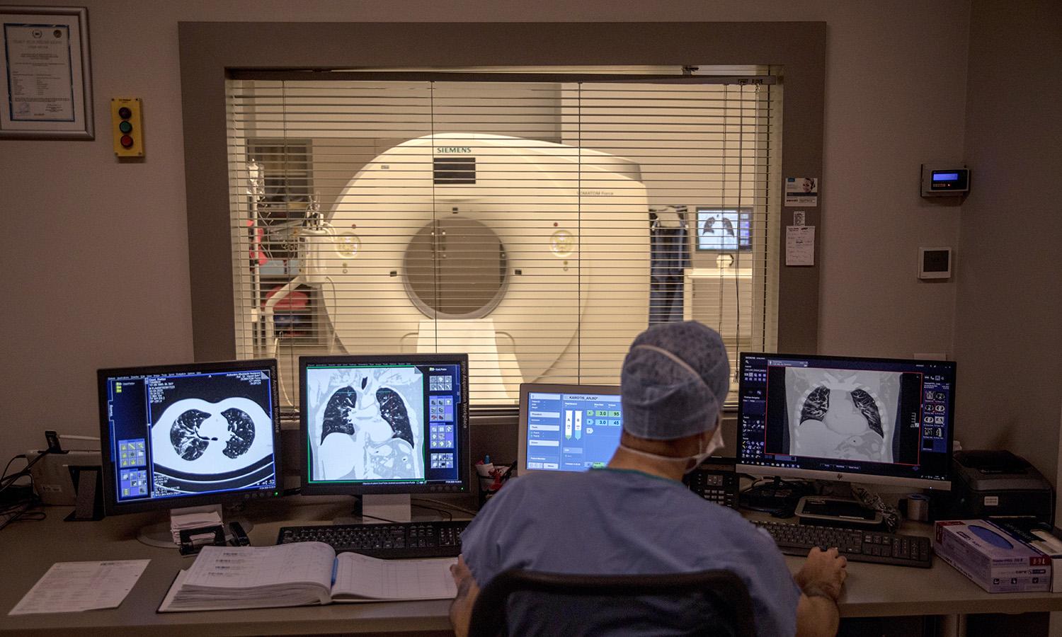 A radiologist looks through scans of a patient at the Acibadem Altunizade Hospital on April 17, 2020, in Istanbul. (Photo by Chris McGrath/Getty Images)