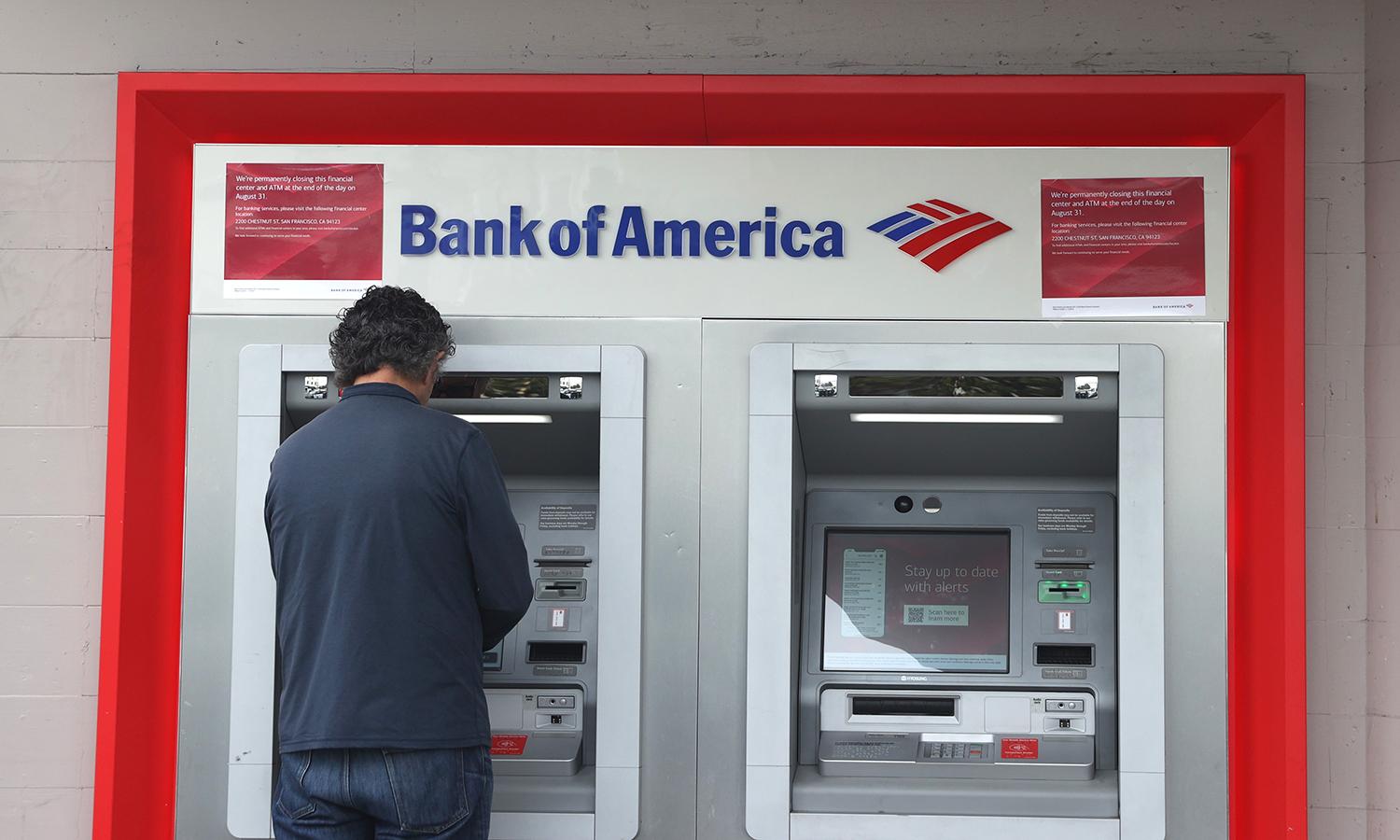 A Bank of America customer uses an ATM at a branch office on July 14, 2021, in San Francisco. (Photo by Justin Sullivan/Getty Images)