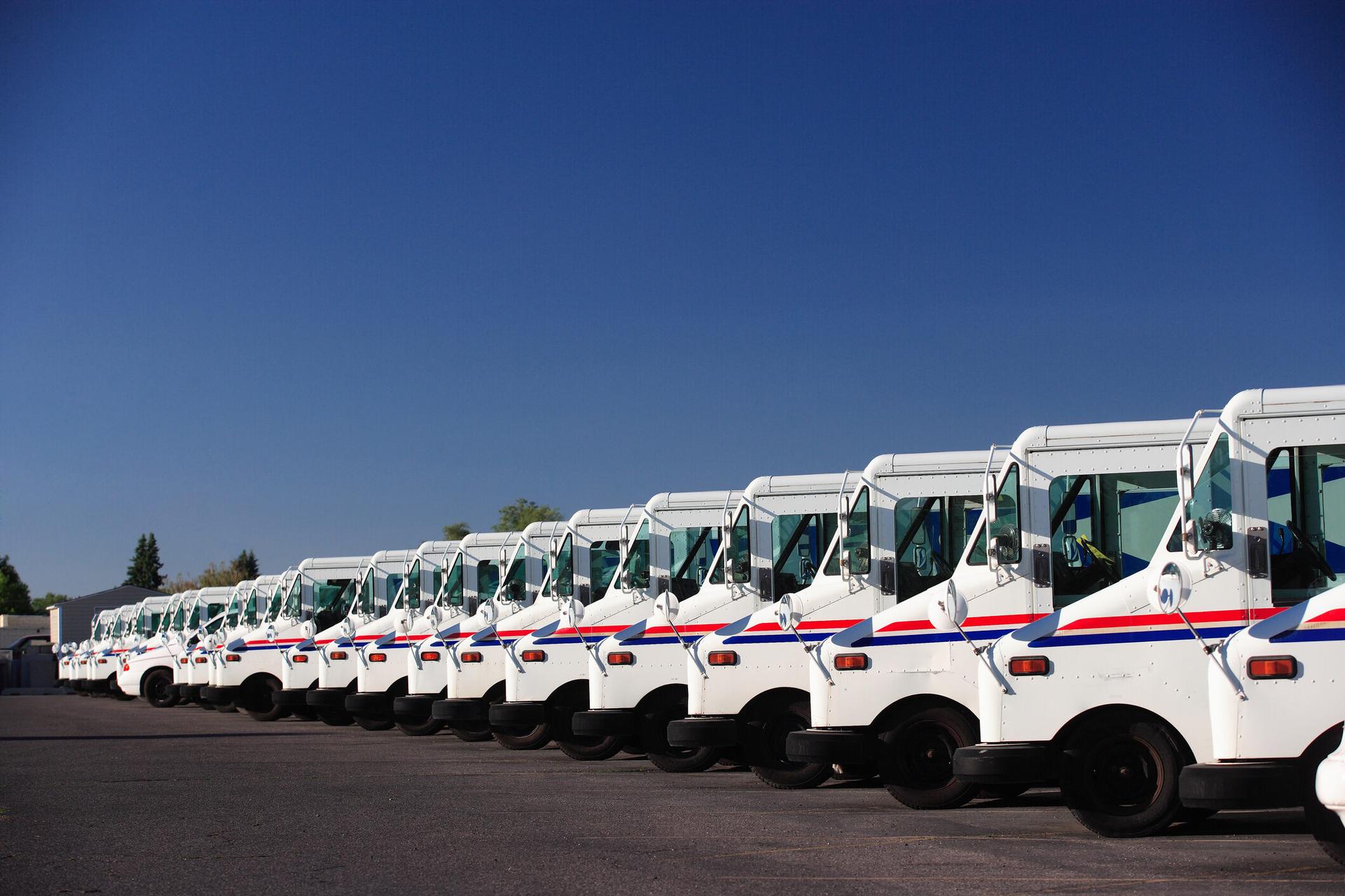 A fleet of U.S. Postal Service vehicles parked in a line. The U.S. Postal Service is expanding the use of an emergency records systems to cover ransomware attacks and other cybersecurity incidents. (Photo credit:
BrianBrownImages via Getty)