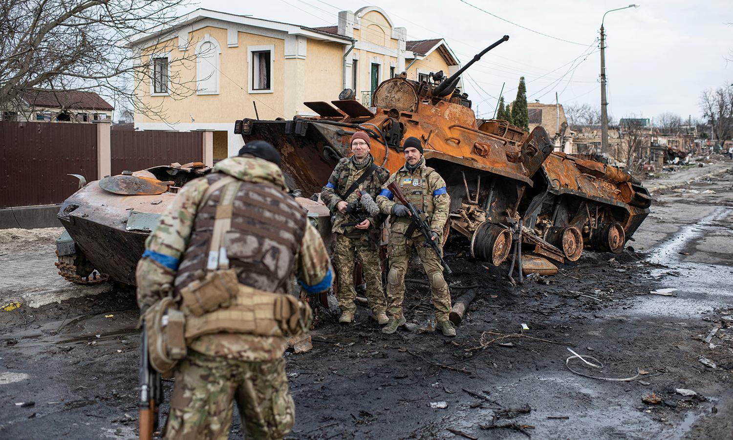 GuidePoint Security data shows ransomware attacks increased in 2022 over the same period in 2021, despite the Russian invasion of Ukraine. Pictured: Members of territorial defense take photos next to destroyed Russian armored personnel carriers on April 4, 2022, in Bucha, Ukraine. (Photo by Alexey Furman/Getty Images)