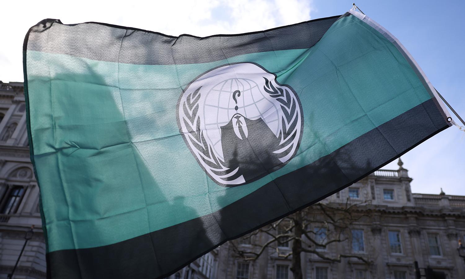 A demonstrator waves a flag of the hacking group known as &#8220;Anonymous&#8221; during The People&#8217;s Assembly Cost of Living Crisis protest on April 2, 2022. in London. (Photo by Hollie Adams/Getty Images)