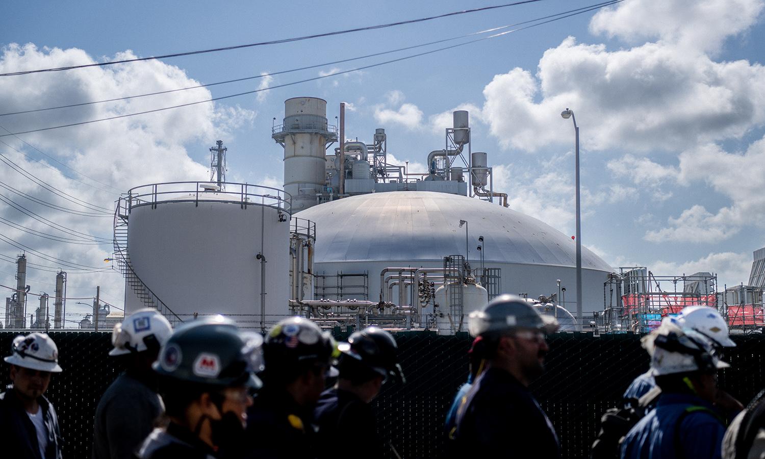 Dragos is offering small- and medium-sized industrial asset owners and operators free tools to help manage their security. Pictured: Workers exit the Marathon Galveston Bay Refinery on May 10, 2022, in Texas City, Texas. (Photo by Brandon Bell/Getty Images)