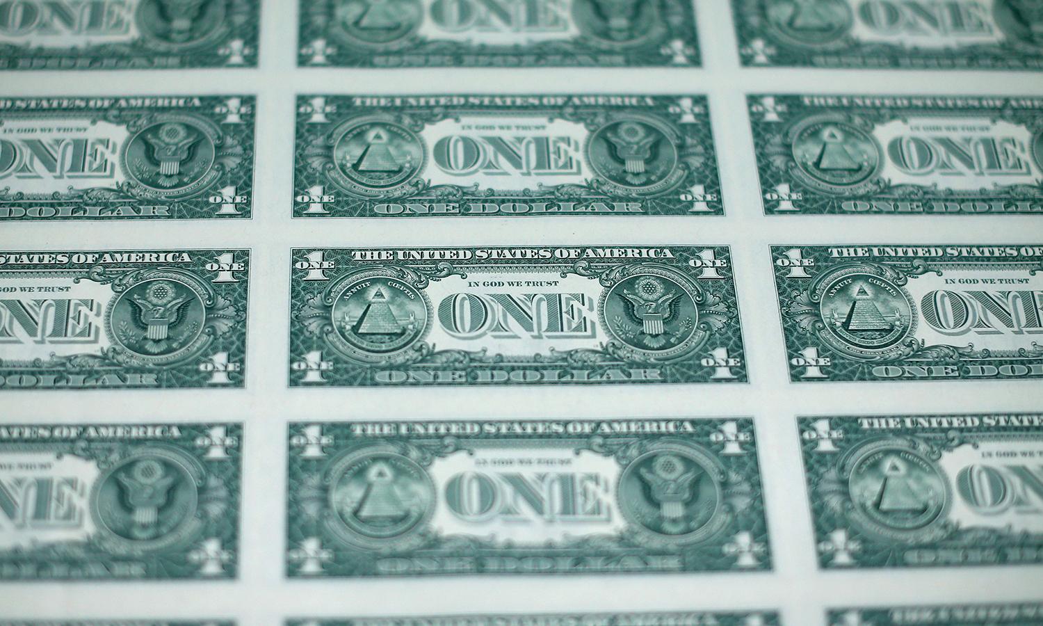 A sheet of freshly printed one dollar bills is ready for inspection at the Bureau of Engraving and Printing.