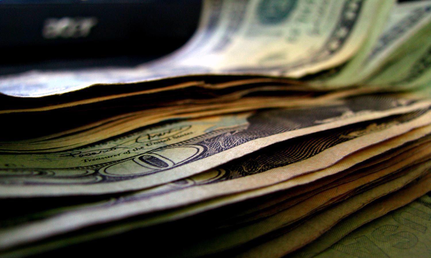 A close-up view of a stack of U.S. currency.
