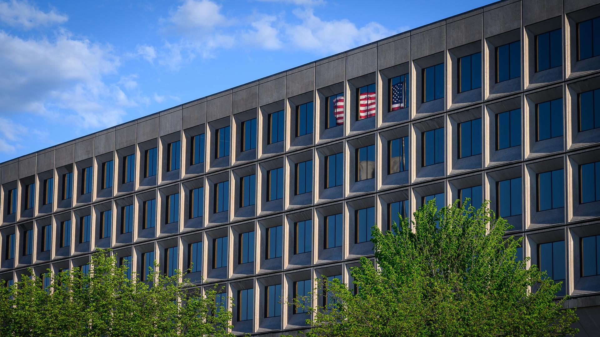 U.S. Department of Energy with the American flag reflected in the windows.