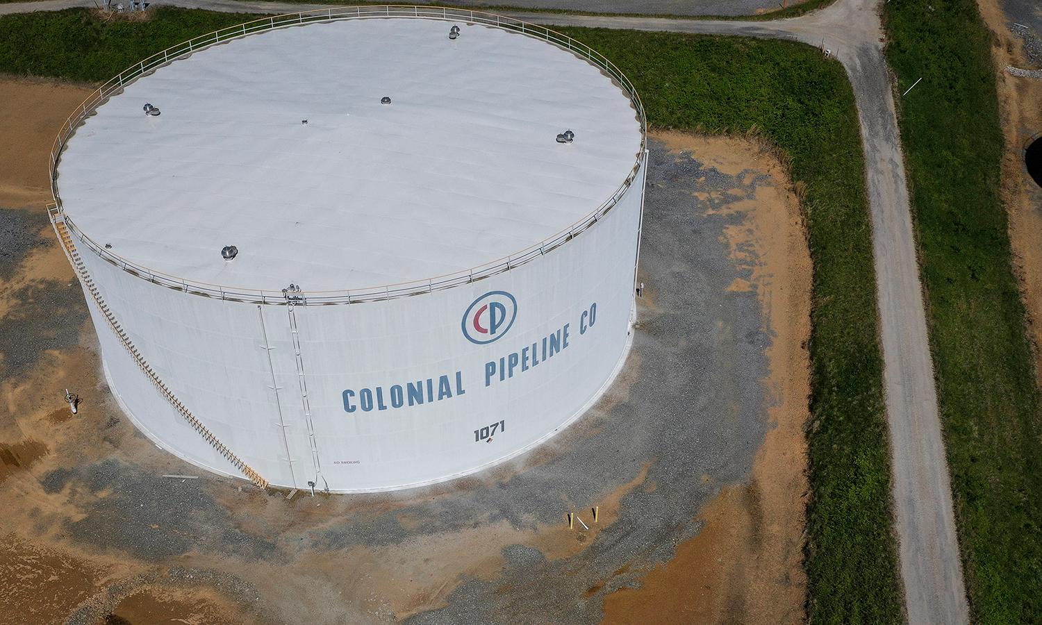 A white fuel holding tank for Colonial Pipeline is seen from the air.