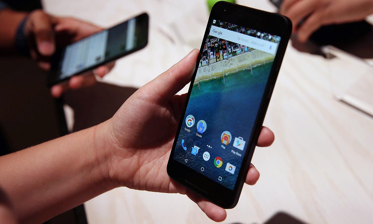 A person inspects a Nexus 5X phone