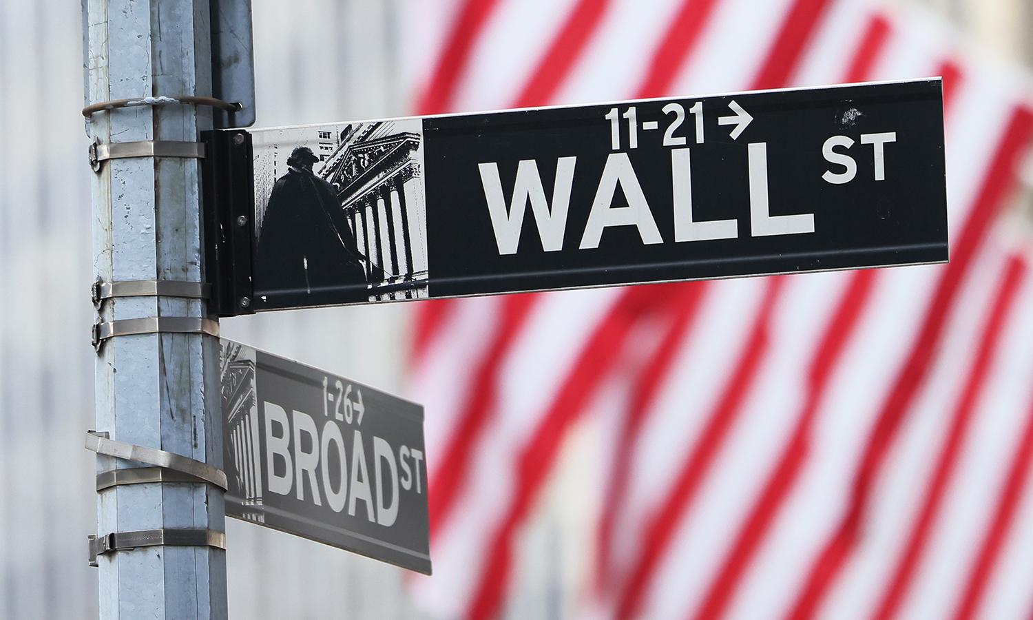 A Wall Street sign is seen outside of the New York Stock Exchange on June 8, 2022, in New York City. (Photo by Michael M. Santiago/Getty Images)