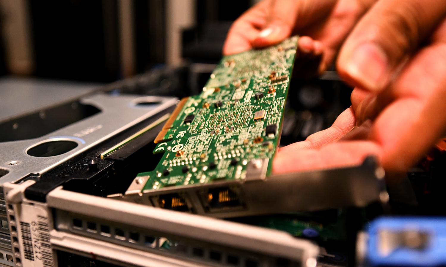 An Air Force information technology specialist replaces a circuit board during server maintenance, Sept. 22, 2021, at U.S. Army Garrison Humphreys, South Korea. (Air Force)