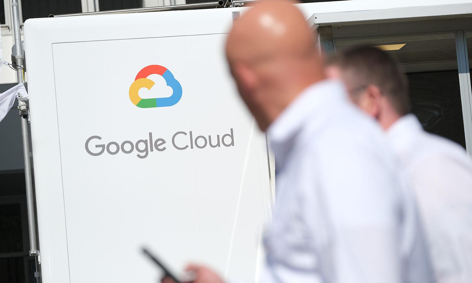 The Google Cloud logo is displayed as people walk by in the foreground.