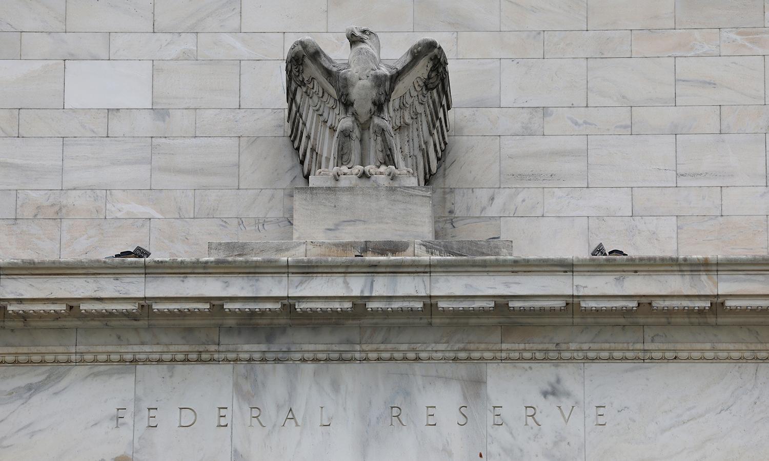A statue of an eagle sits atop the Federal Reserve building.