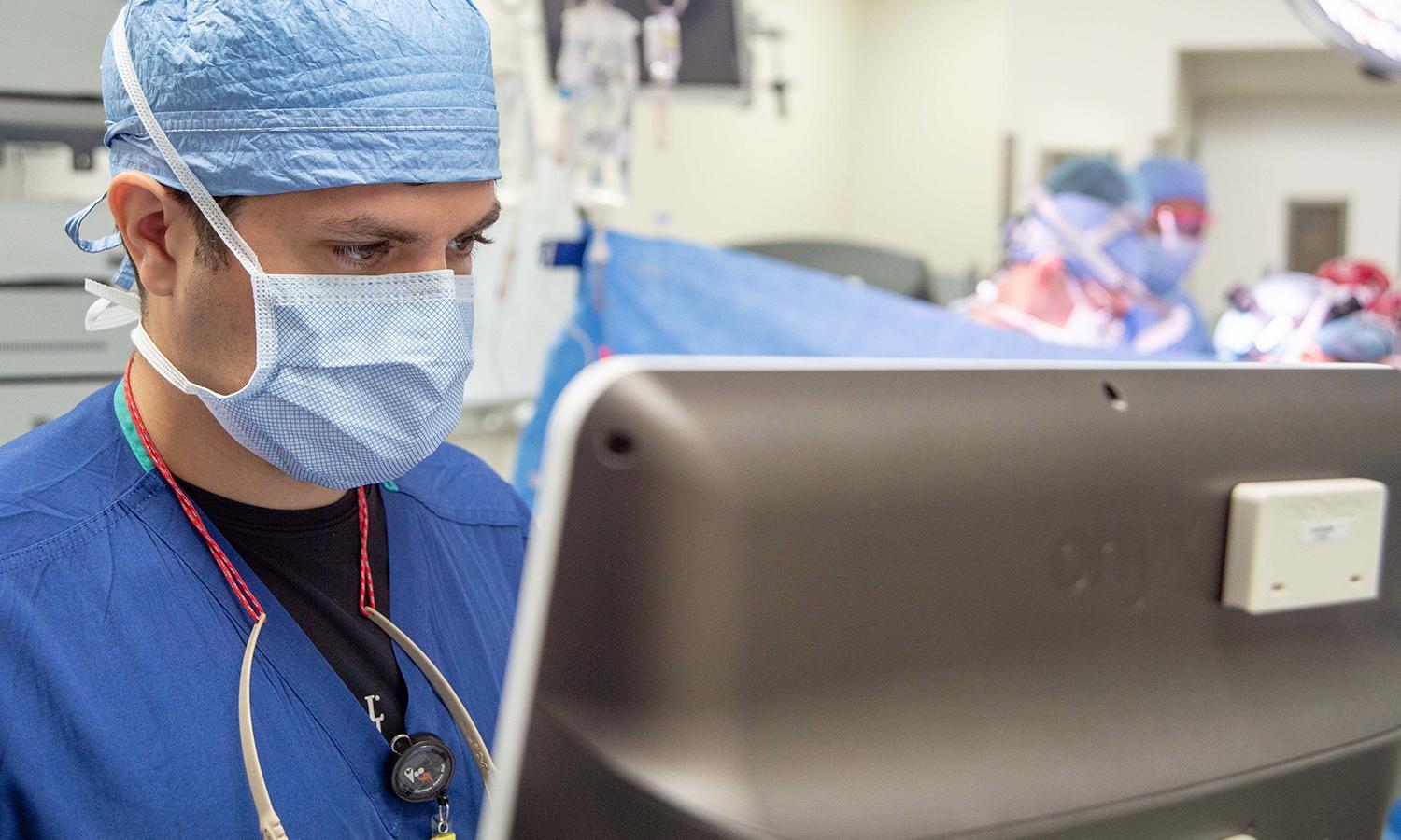An anesthesiologist monitors a patient's vital signs during surgery.