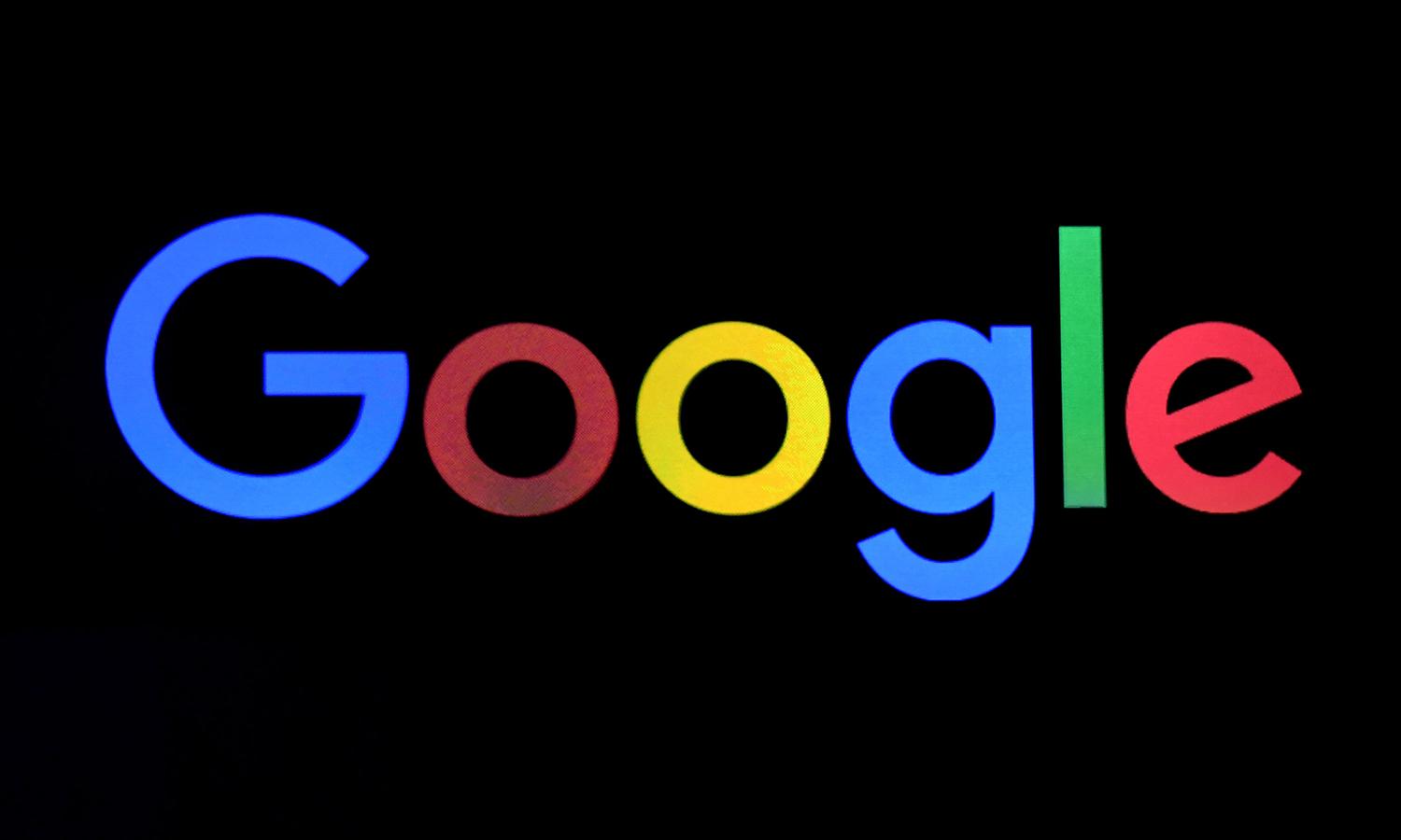 A Google logo is shown on a screen during a keynote address.