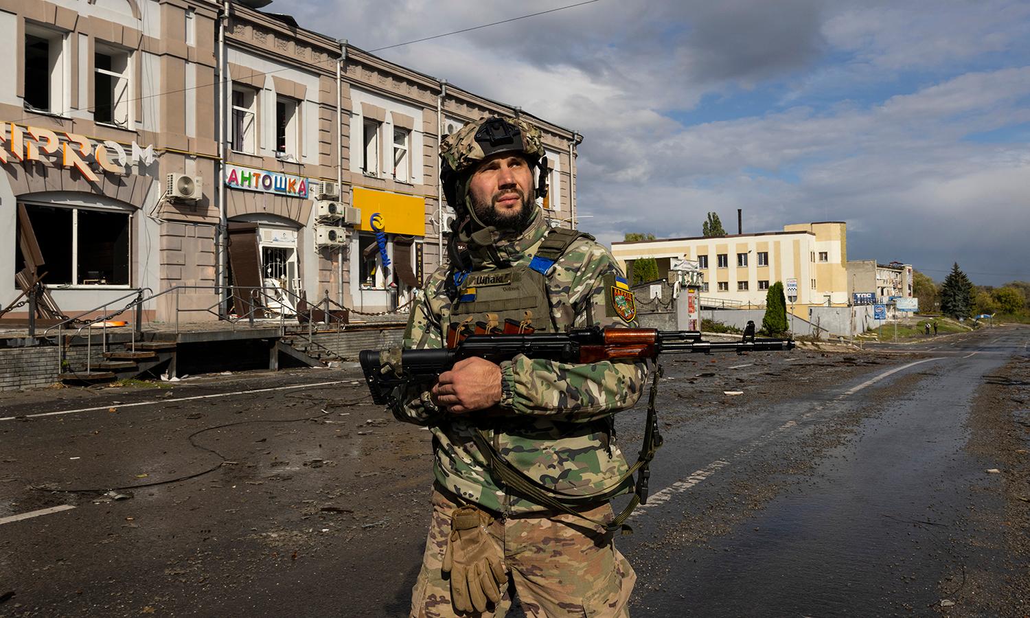 A Ukrainian soldier patrols empty streets