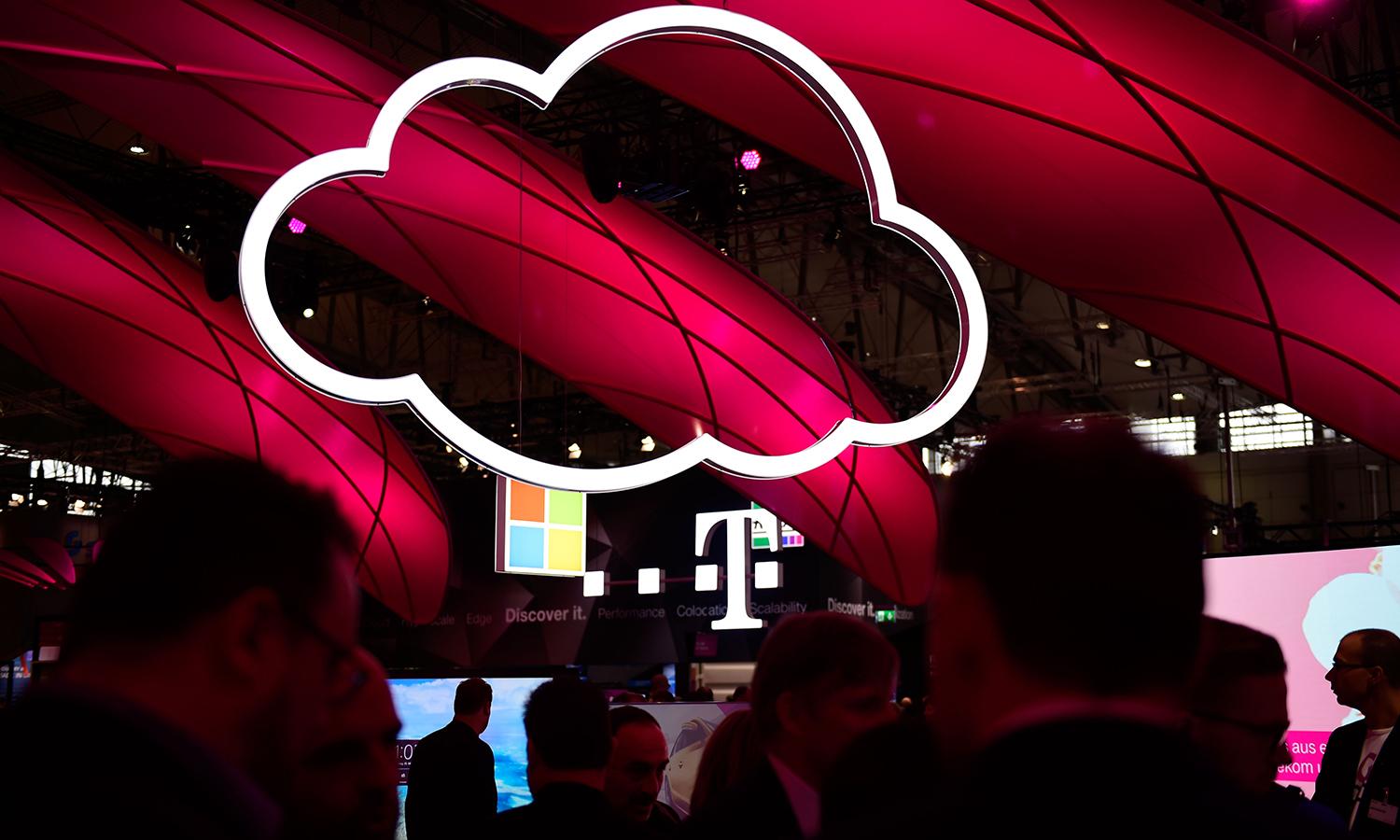 An illuminated cloud is seen at a technology fair.