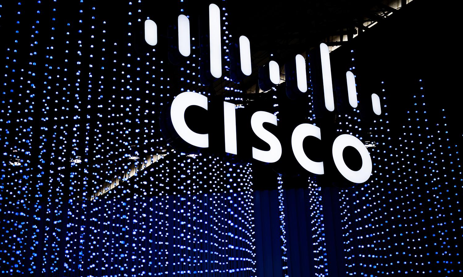 A Cisco logo sits illuminated at a conference.