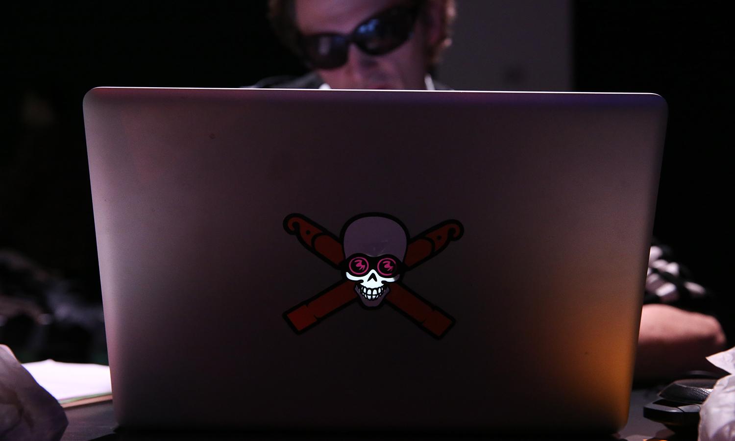 A hacker uses a laptop
