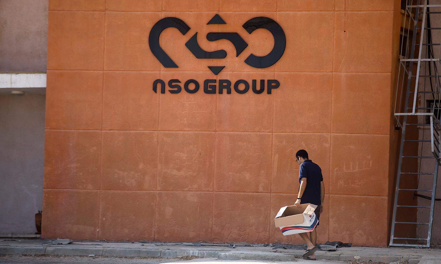 A man walks by the building entrance of Israeli cyber company NSO Group
