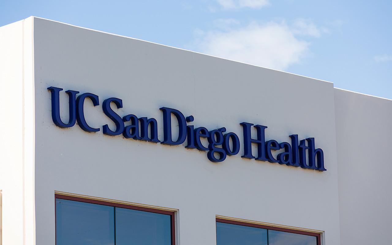 UC San Diego Health sign on hospital building facade.