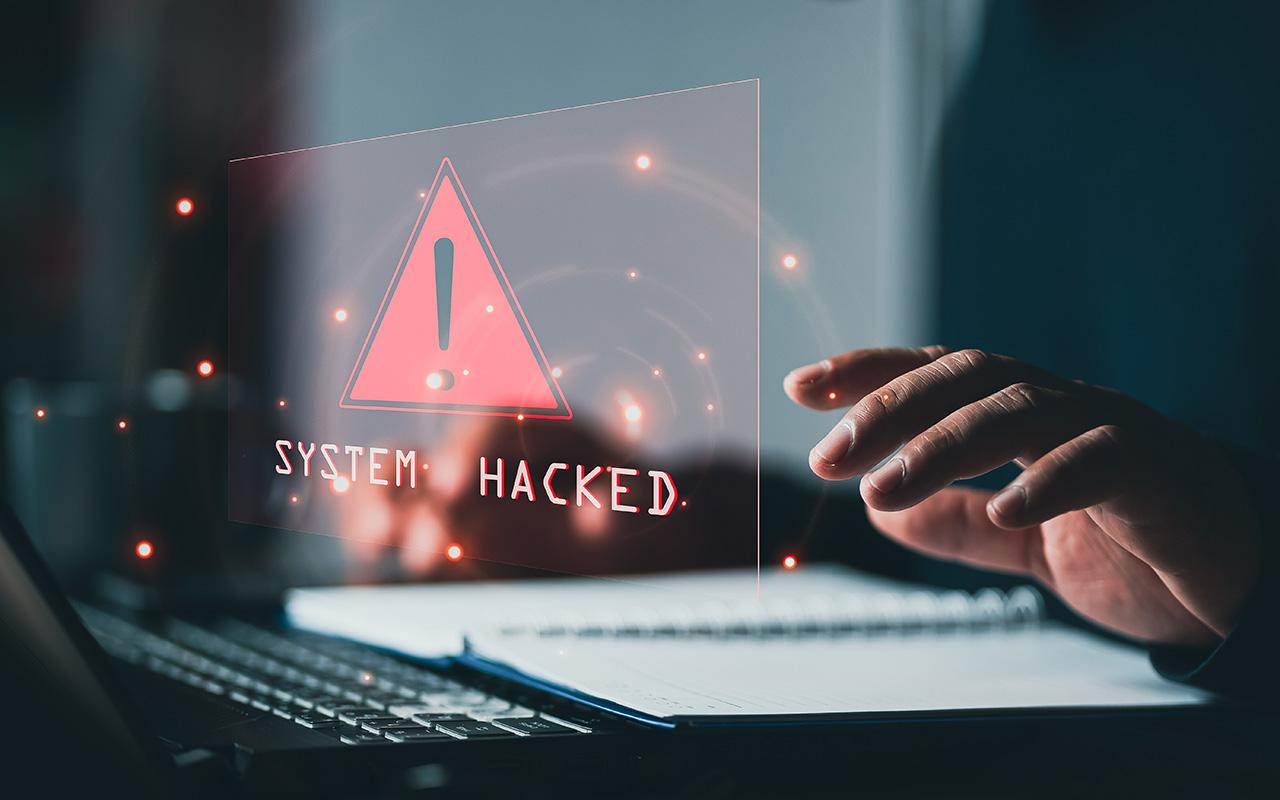 System hacked alert after cyberattack on computer network.