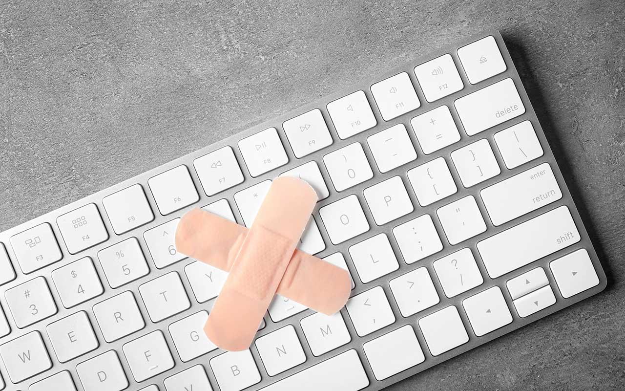 Two Band-Aids create an X on a computer keyboard