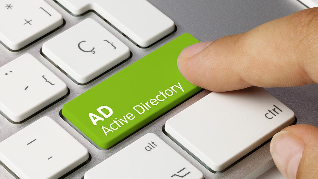 AD Active Directory written on green key of a computer keyboard.